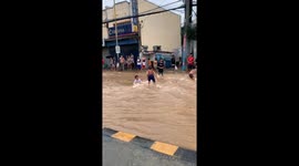 Children play in floodwaters caused by typhoon Gaemi in Cainta, Rizal, Philippines