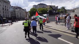 Drinks thrown at activist carrying Palestine flag is escorted by police during Tommy Robinson rally