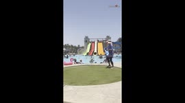 Family holiday: Grandad steps in to help granddaughter slide with joy
