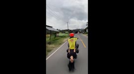 Dangerous freestyle action in indonesia by a pair of teenagers, their heads almost touching the asphalt of the highway