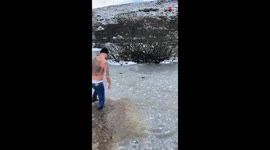 Man walking on frozen pond catches a break and falls for ice-cold water... LITERALLY!