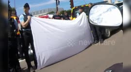 Grave accident in Versailles, France, Paris suburb, Place de la Loi roundabout. (28 july 2024. ~ 14h00). Gendarmes (~police) hold a tarpaulin to hide the scene from the public. (No precise informations on the victim).