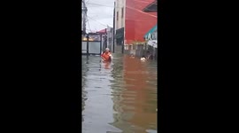 Residents wade through Typhoon Gaemi floods in the Phillipines