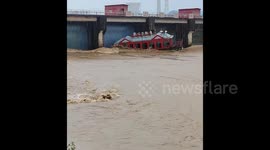 Giant tourist boat sucked into underwater bridge tunnel during severe floods in China