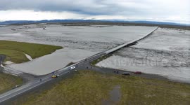 Drone footage shows glacial flood engulfing river bridge in Iceland