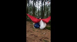 Girl's joyful chat ends in a surprise fall as the hammock tears apart