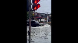 SUV navigates flooded streets, nearly collides with swimmer in Manila