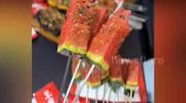 Street vendor turns fresh watermelon into popular BBQ snack