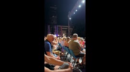Famous singer and actor Rade Serbedzija in Sarajevo singing just before huge summer storm, sky with lightning all around