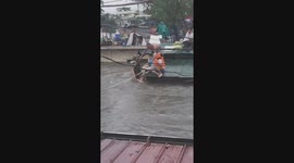Neighbours rescue fellow residents stranded on roof during typhoon floods