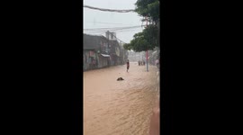 Resident winds through flood on waveboard