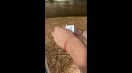 Person slips and falls after placing paper boat in rain water in Chivilcoy, Argentina