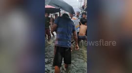 Kind residents help pull car that fell into flooded canal