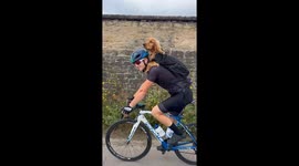 Bicyclist gives pup piggyback ride