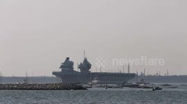 Crowds watch HMS Queen Elizabeth Fires Naval Gun Salute at Cowes Isle of Wight as she returns to Portsmouth after repairs