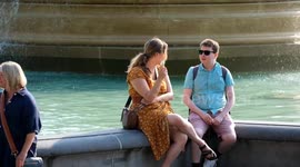 People enjoy the sun on the hottest day of the year so far in Trafalgar Square