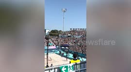 Spectators perform 'stadium wave' during beach volleyball match at Olympics