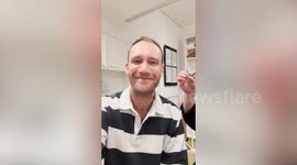 Man's emotional reaction after trying on hearing aid for the first time