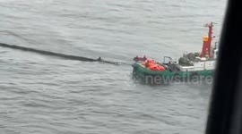 Philippine Coast Guard lay out oil spill booms around sunken tanker