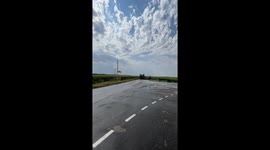Driver performs stunt by passing under moving truck in Rostov-on-Don, Russia