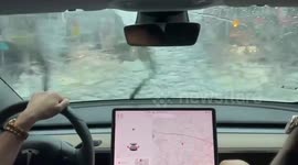 Tesla driver takes car for a joyride through flooded streets after deadly typhoon