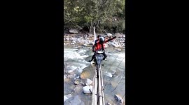 The extreme residents were determined to cross a very dangerous bridge using motorbikes, the bridge only had a few planks and bamboo floors