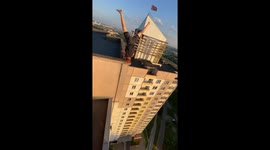 Man performs headstand on high-rise building edge in Minsk, Belarus