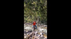 The extreme residents were determined to cross a very dangerous bridge using motorbikes, the bridge only had a few planks and bamboo floors