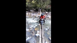 Dare to cross this makeshift bridge made from dangling pieces of wood?