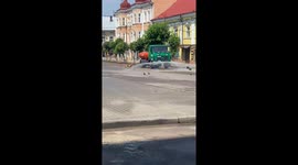 Dog plays with water from truck in Sambir, Ukraine