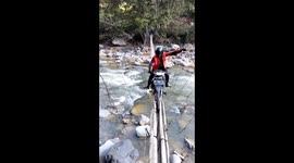 Extreme! Residents fight for their lives recklessly across a very dangerous bridge using motorbikes, which only have a few planks and a bamboo floor