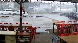 Advertising billboard collapses during storm and almost hits car