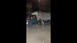 People helped push the truck to help the driver and his daughter escape the flooded area