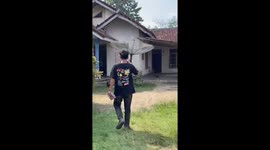 Man flees from dogs after visiting home in Lampung, Indonesia
