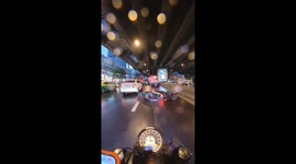 Motorcyclist falls on slippery road in Bangkok during rain