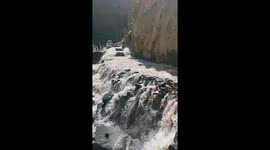 Car navigates hazardous rocky and water-filled road in Pangi, Himachal Pradesh, India