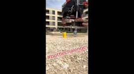 Man pours water into a glass with no spills during the 'Bottle Challenge'