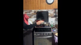 Brazilian woman spills shrimp while cooking