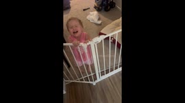 Toddler learns to open the baby gate during family vacation at aunt's house