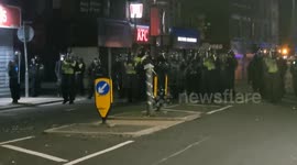 Riot Police charge at protesters who hurl barricades & bricks at them
