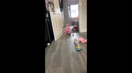 Baby girl remains unbothered by ball-pit balls in her babygrow