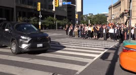 Car sideswiped in downtown Toronto, pedestrian hands driver back part that fell off during the crash to save him from having to get out and inspect the damage himself. LOL