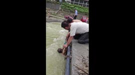 Elderly man rescued from river by police, residents
