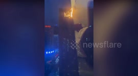 Fire erupts at top of high-rise hotel in China