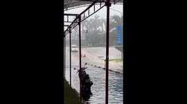 Traffic barriers slide down flooded road like they have race