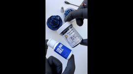 Masterful piping of royal blue and black Buttercream Rosette Cupcake with elegant sprinkles