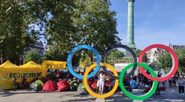Activists set up refugee camp next to Olympic rings in Paris as part of protest