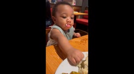 Little girl enjoys hot mashed potatoes during dinner with her mom