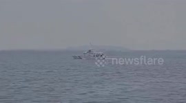 Philippine Coast Guard sprays oil dispersant around sunken ship