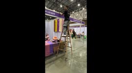Handyman uses ladders as walking stilts to fix stall roof